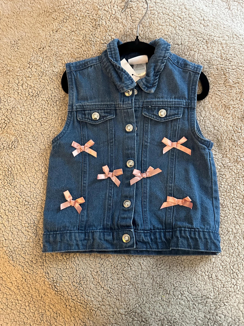 Denim vest with butterfly glitter on back with pink bows on front