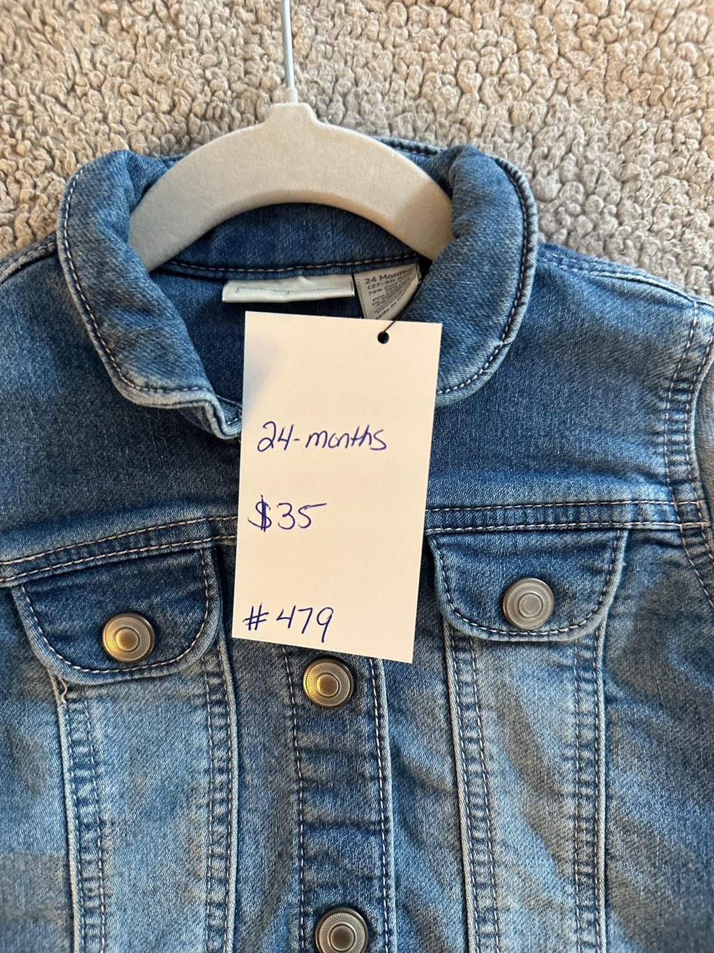 A loader and dump truck on back of denim jacket