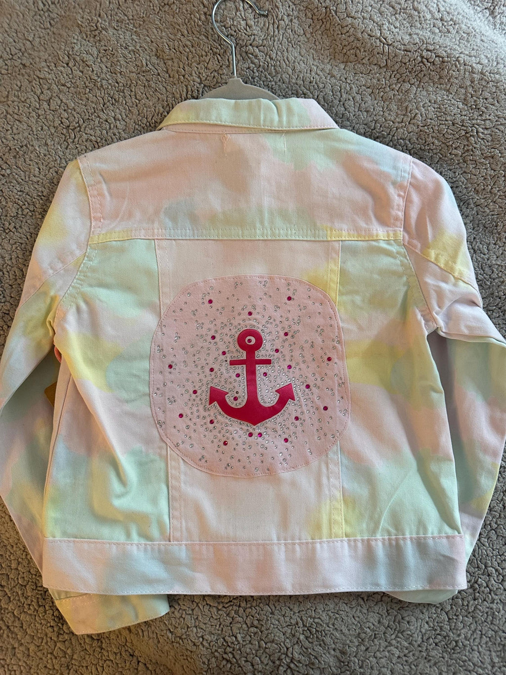 Pink anchor on tie dye denim jacket
