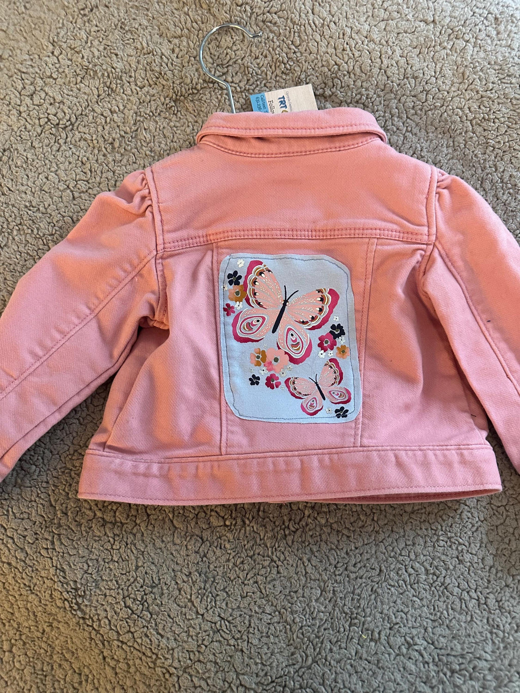 Pink denim jacket with pink butterflies on the back